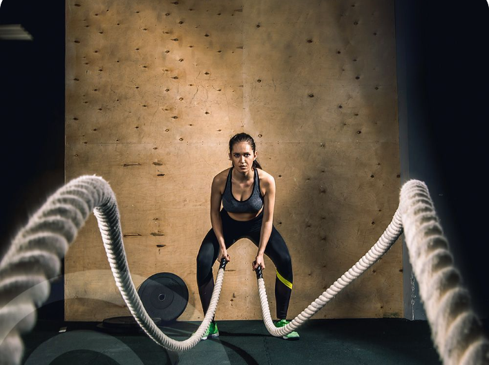 Group of five people high-fiving in a gym