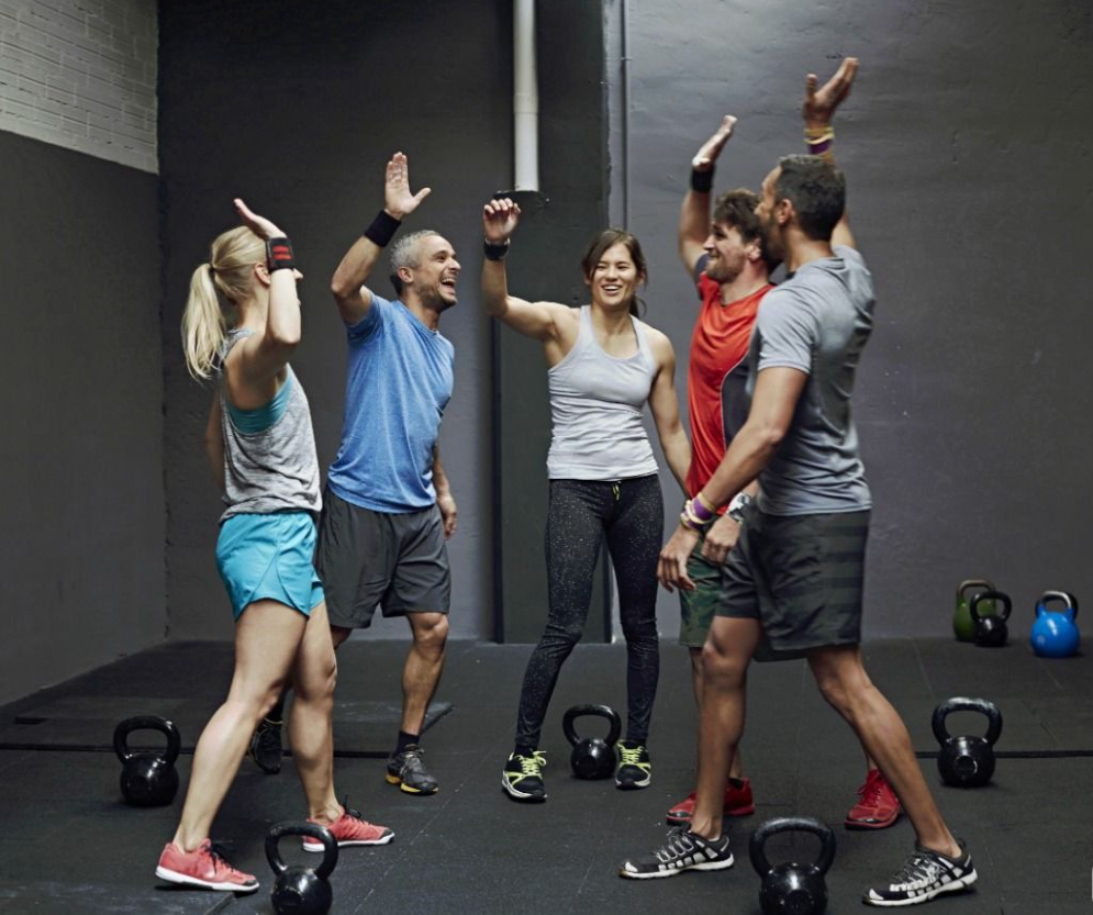 Group fitness class using kettlebells and battle ropes